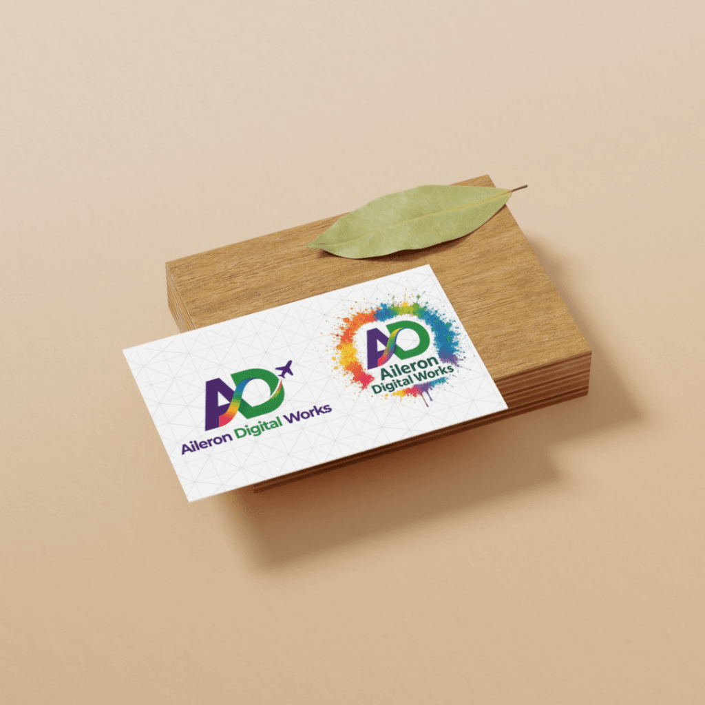 Aileron Digital Works business card displayed on a wooden block with a green leaf.
