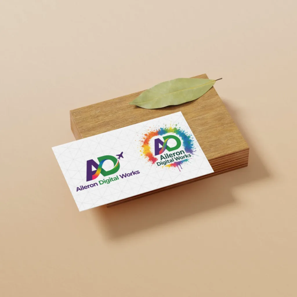 Aileron Digital Works business card displayed on a wooden block with a green leaf.