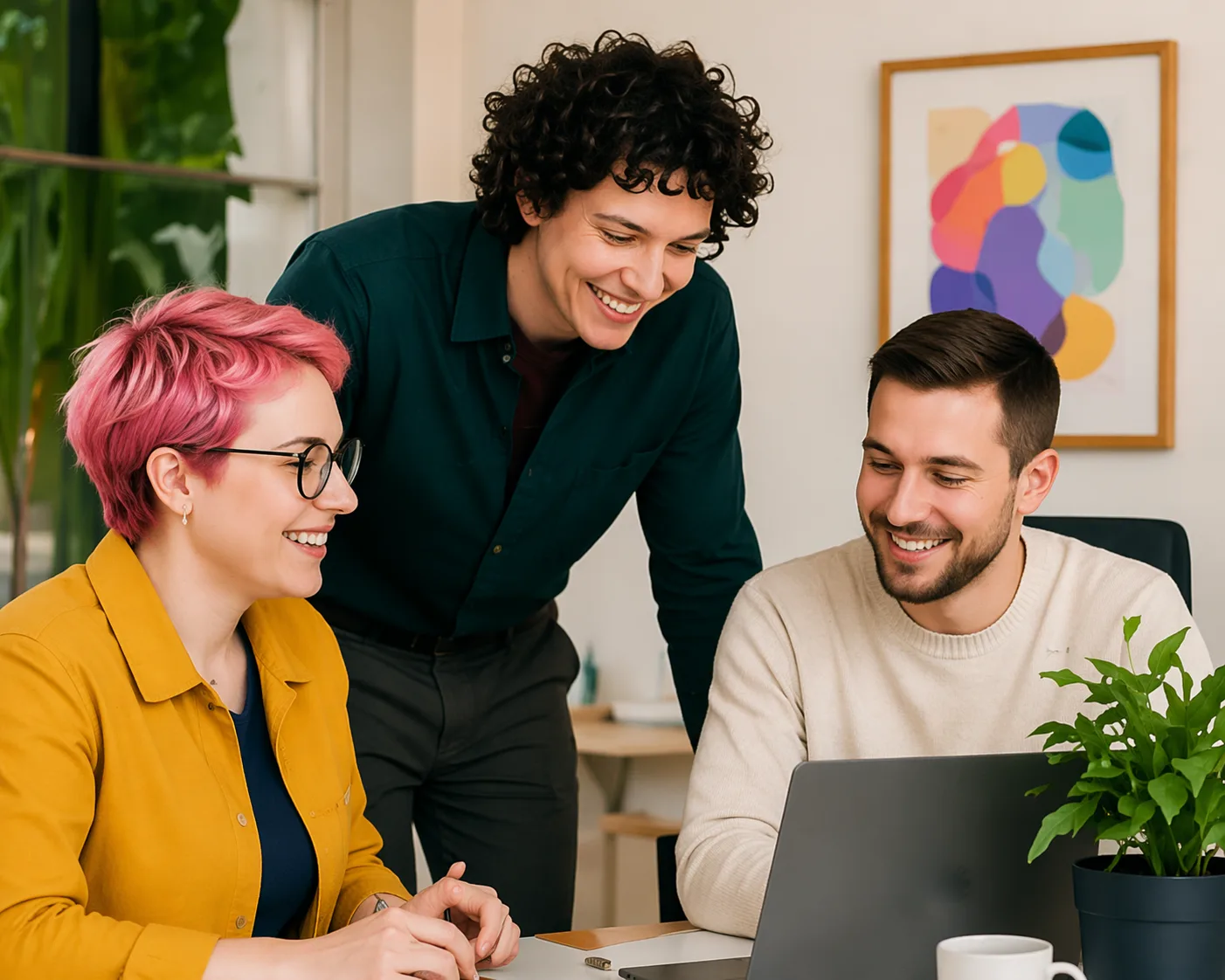 Three people looking at a laptop